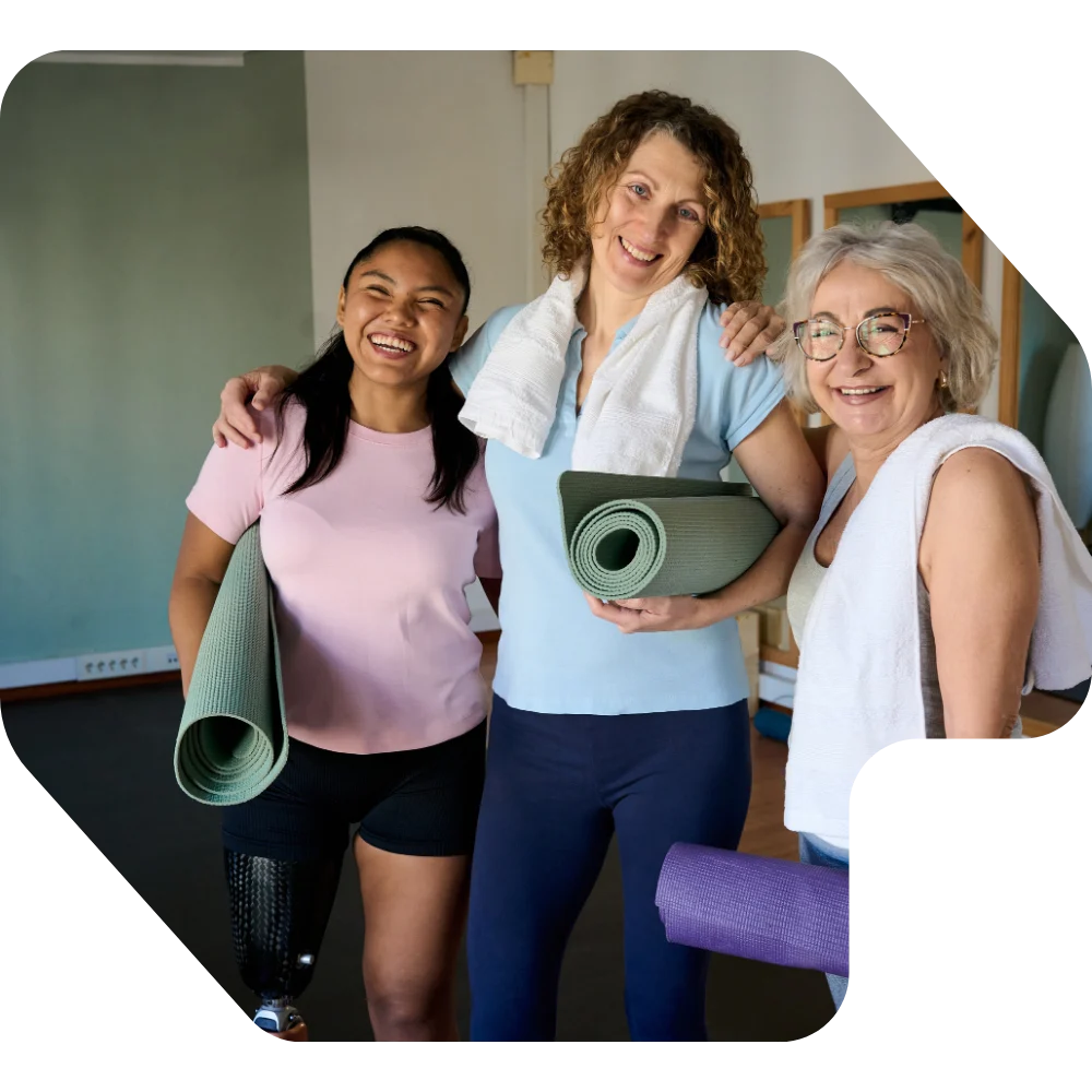 Disabled woman with two friends in yoga class