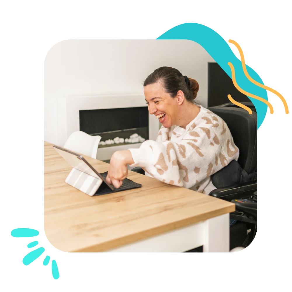 Disabled woman in wheelchair smiling while using tablet