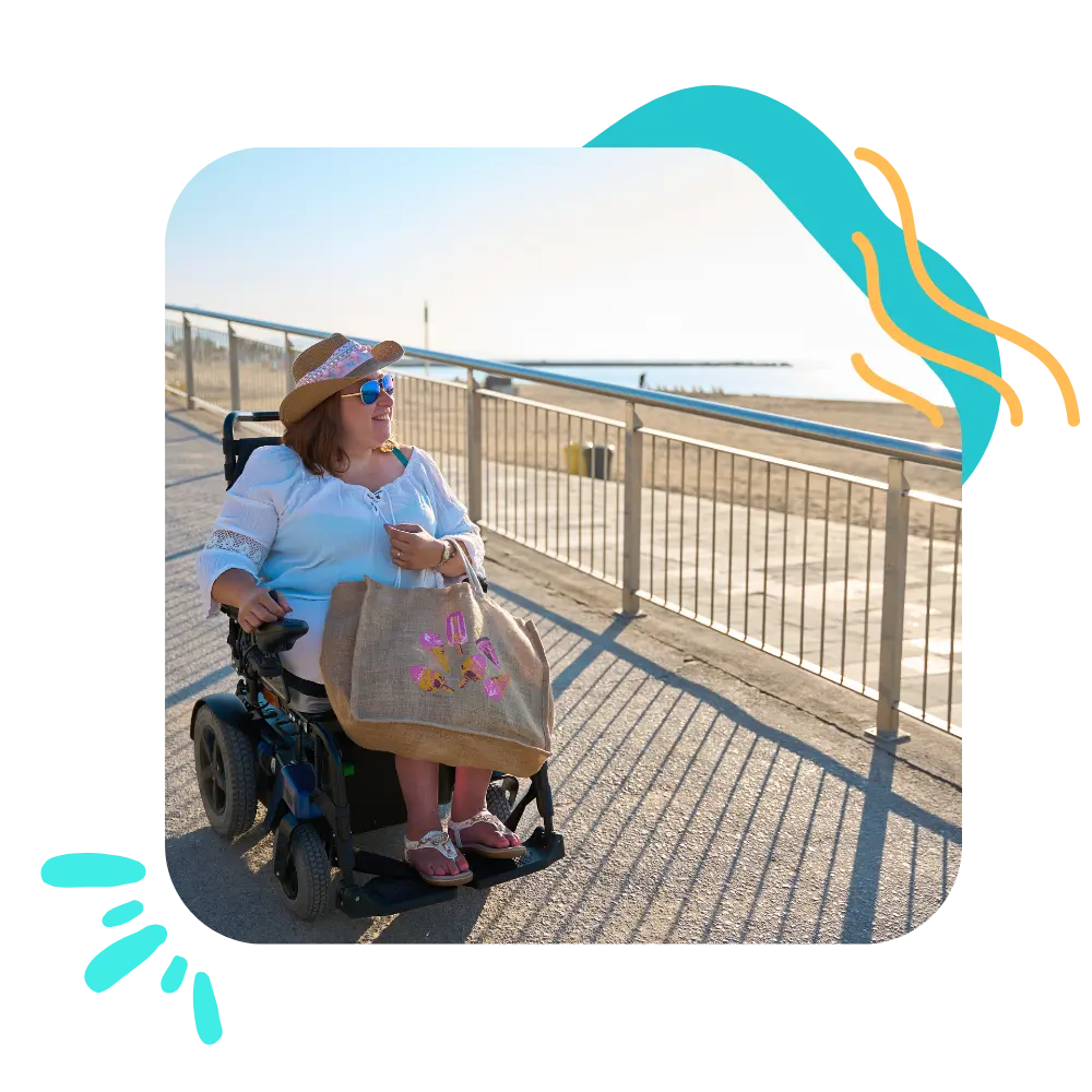 Disabled woman in wheelchair at the beach